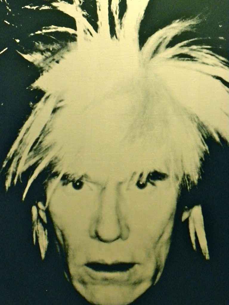 Image of Andy Warhol in a self portrait.