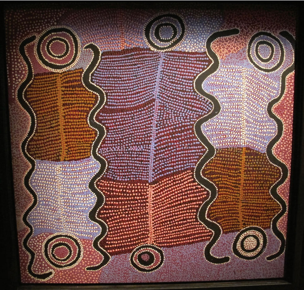 Photo of designs made in sand in hues of red, purple, brown, white