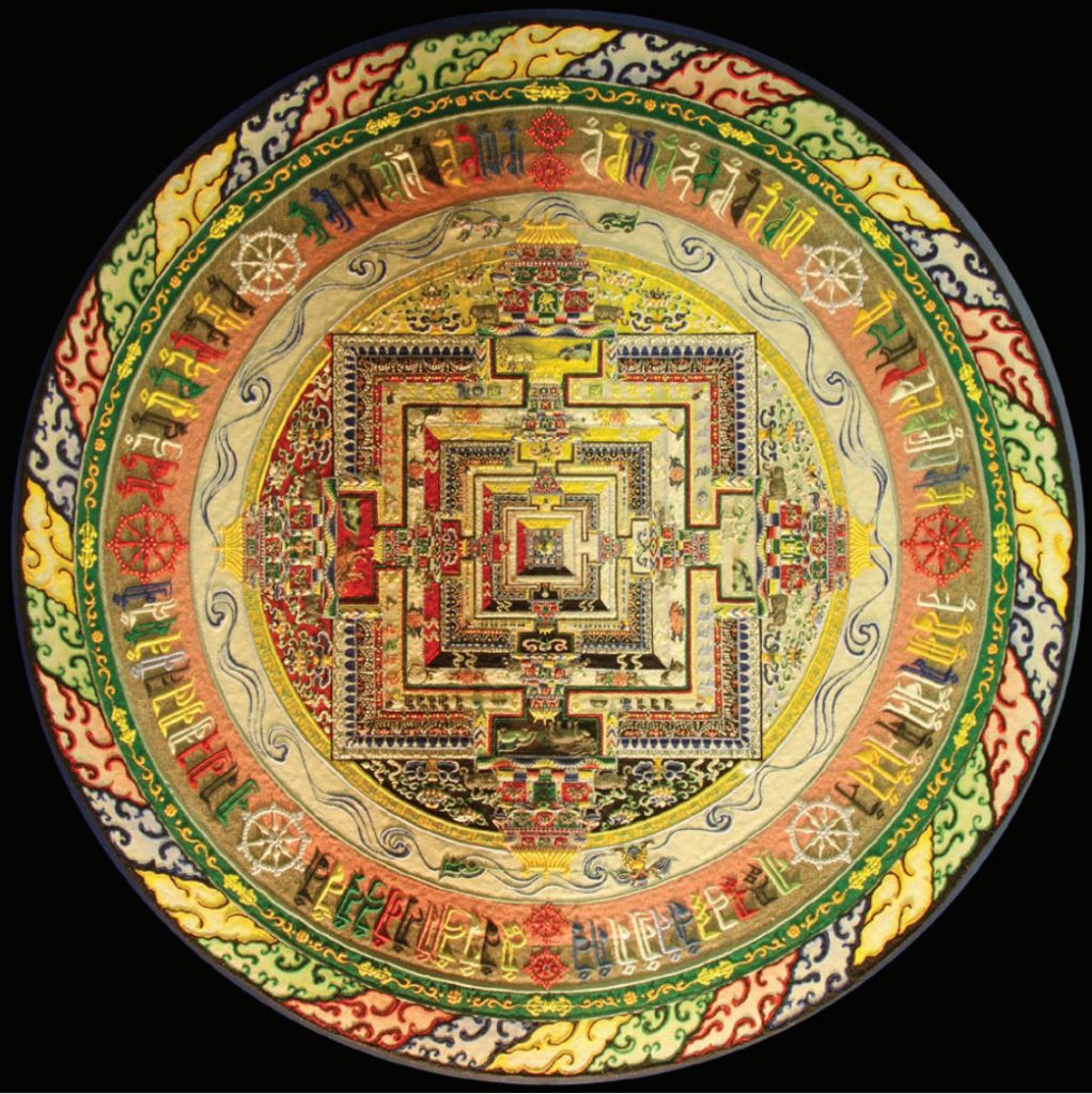 Photo of mandala in circular form with very detailed designs in hues of green, red, purple, yellow, black
