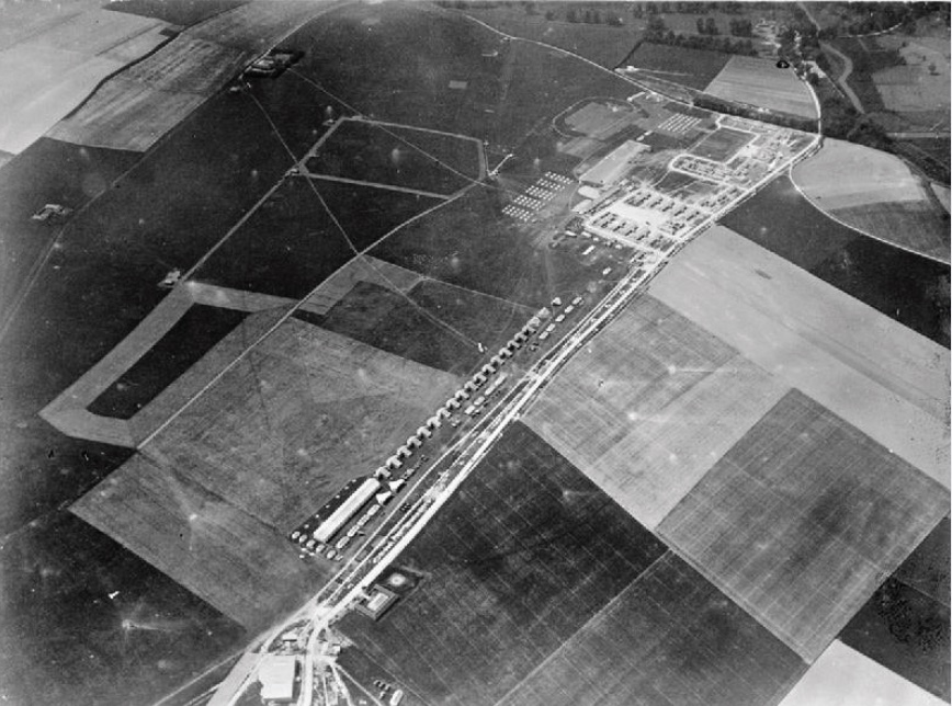 Black and white aerial photograph of mostly agricultural landscape.