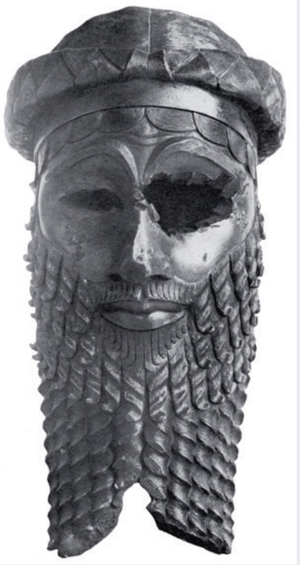 Photo of a bronze head of a king with eyes gouged out.