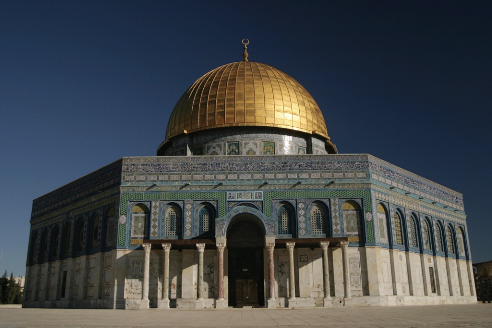 Photo of Dome of the Rock shrine showing gold dome on top with green trim around side.