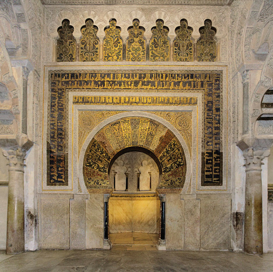 Photo of interior of mosque with lavish decorations and structures.