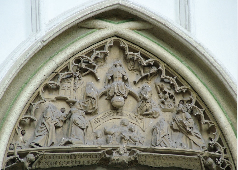 Photo of church portal with religious figures' heads chopped off of scene.