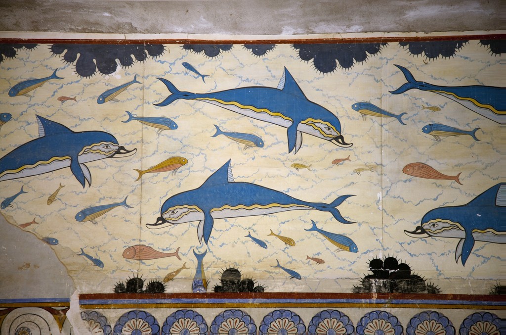 Dolphins and small fish painted in a pattern on a fresco.