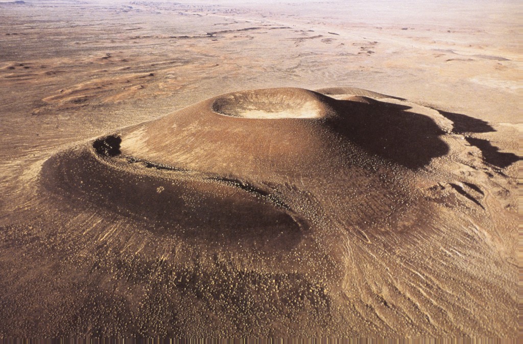 Image of Roden Crater, project by James Turrell. A volcanic cone from an extinct volcano being turned into a massive naked eye observatory by James Turrell. Photograph is of exterior landscape.