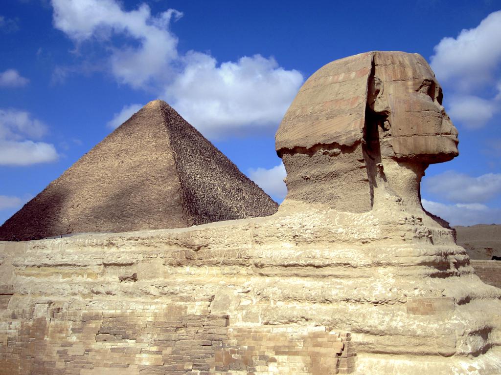 A large pyramid set behind the Sphinx sculpture.