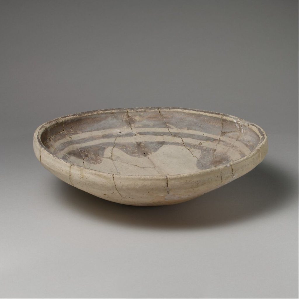Dish decorated with a dark brownish paint in three concentric rings.