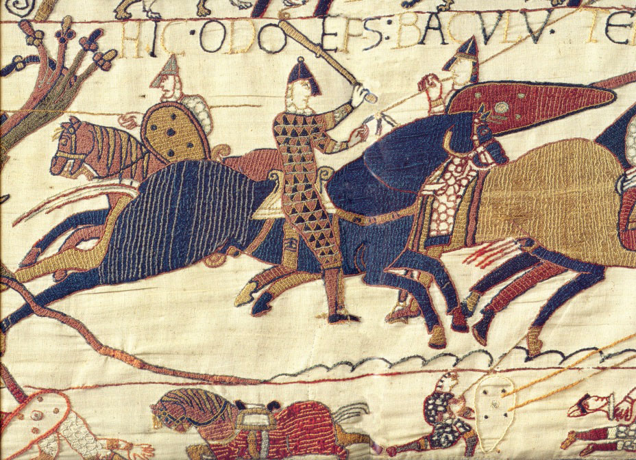 Close up of Bayeux tapestry depicting scene of warriors fighting one accompanied by horses and shields.