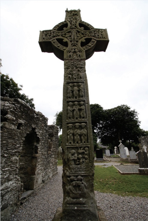 Photo of a Celtic cross in a cemetery.