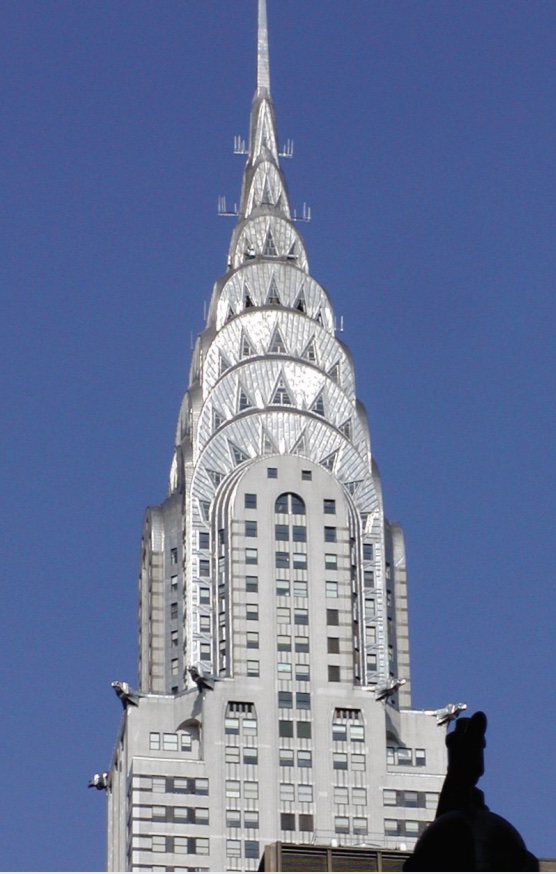 Photo of top of Chrysler building with art deco style top and spire.