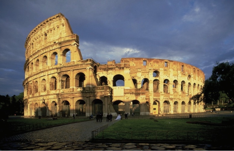 Photo of Colosseum in Rome at sunset.