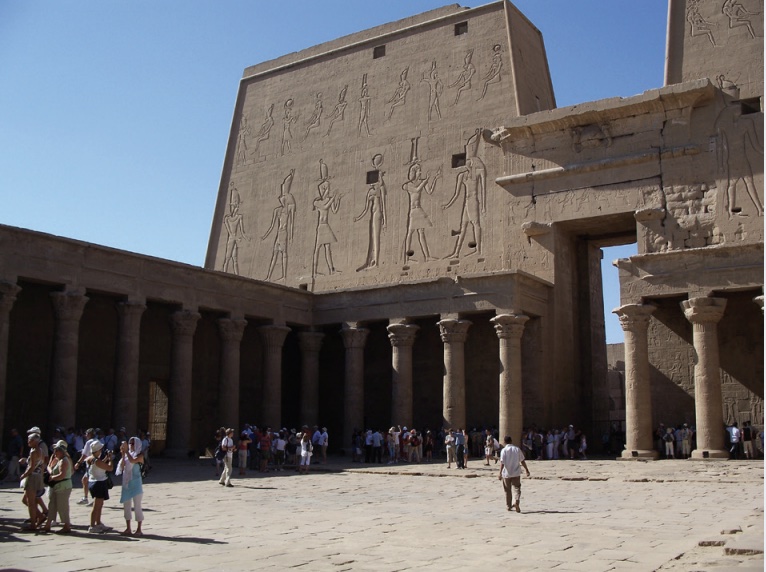 Photo of temple with tall walls and columns around perimeter of interior.