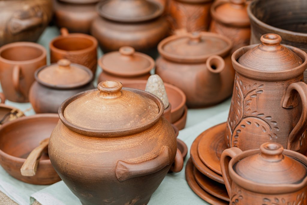Traditional ethnic pottery in the assortment at the fair outdoor, close-up, selective focus.