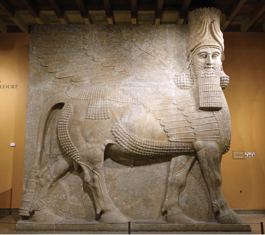 Photo of carving of winged genie figure in animal form.