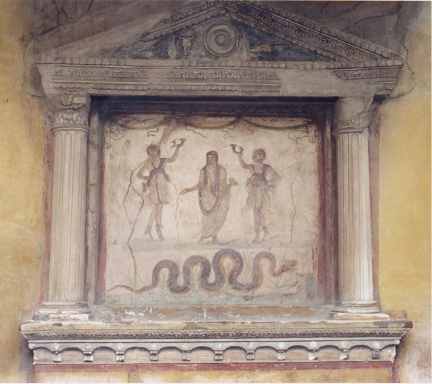 Photo of a scene on a lararium showing two household gods, an ancestor figure, and a snake.