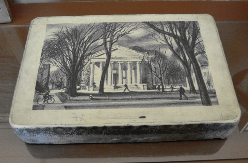 Photo of black and white print on stone depicting white historic building with columns.