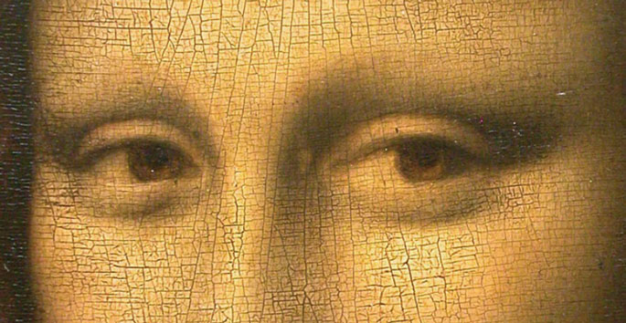 Close up of painting of eyes of Mona Lisa eyes showing cracks in paint and missing eyebrows.