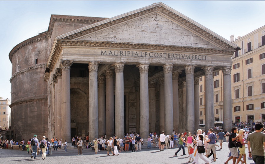 Photo of a stone building with multiple rows of columns at front and circular design behind.