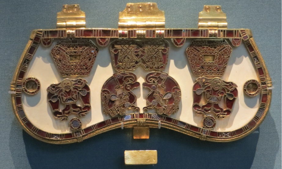 Photo of metal purse lid with intricate designs in golds and reds.
