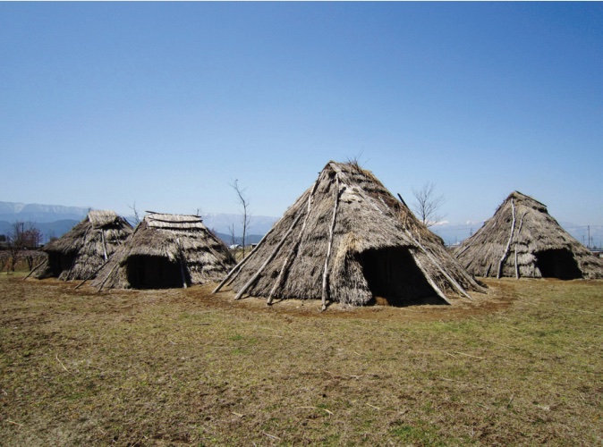 Photo of huts made with natural materials.