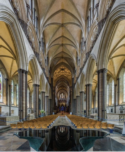 Photo of interior of Gothic cathedral with arches and columns and feeling of light and airy space in ceiling.