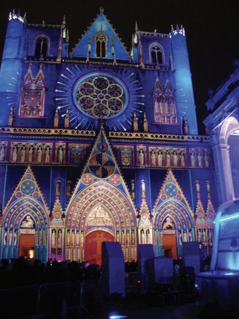 Photo of brightly lit and multiple-colored cathedral at night.