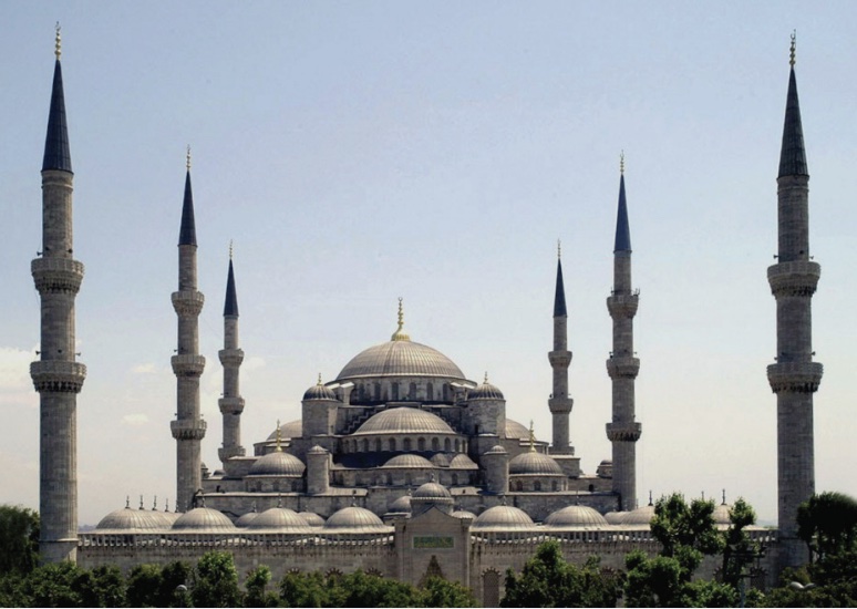 Photo of a mosque with many domes and spires.