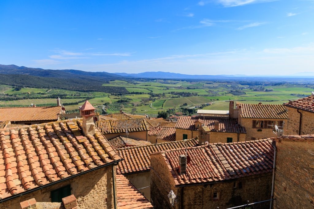 Casale Marittimo Tuscan town rooftop view with ceramic tile roofs.