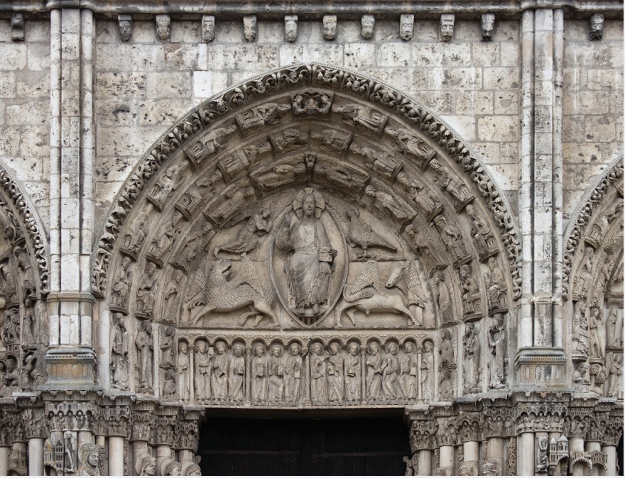 Photo of tympanum above the door of a cathedral with Jesus carved into stonework.