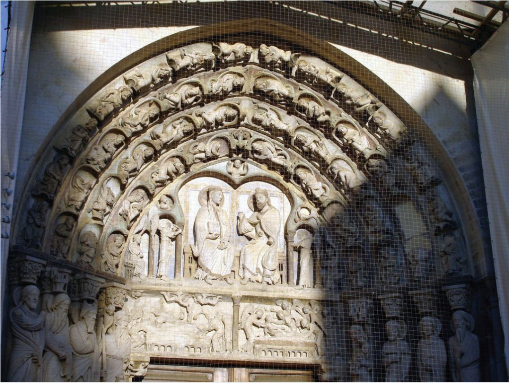 Photo of portal at Notre-Dame Cathedral showing the Virgin Mary and Jesus sitting side by side.