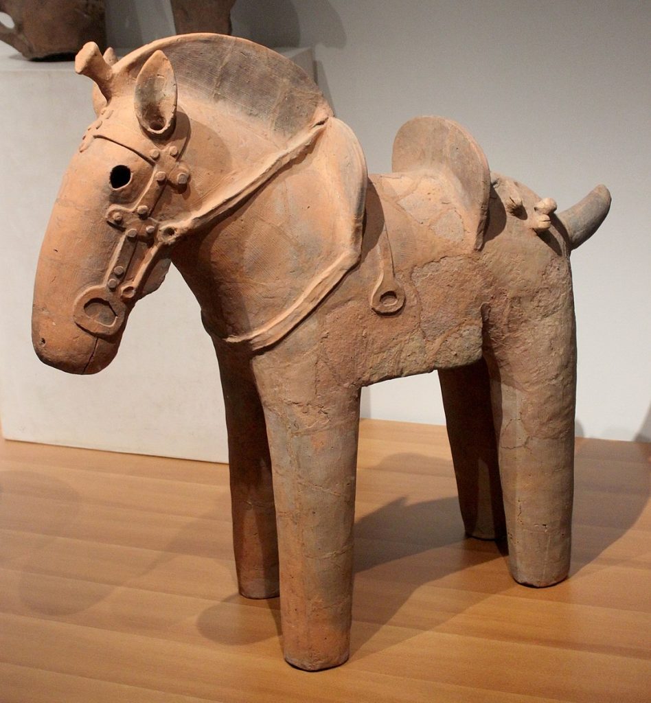 Photo of a Haniwa horse statuette in a museum.
