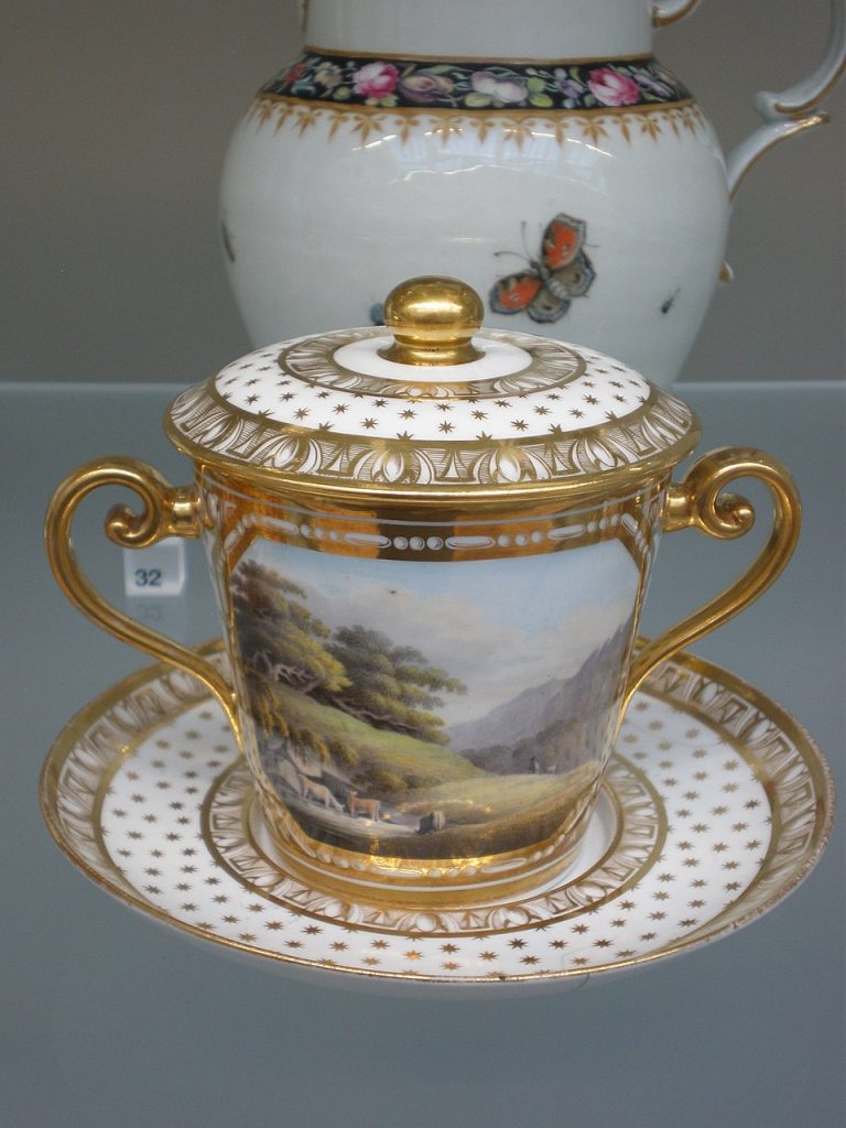Staffordshire bone china covered chocolate cabinet cup sitting on plate, with enamels and gilding.