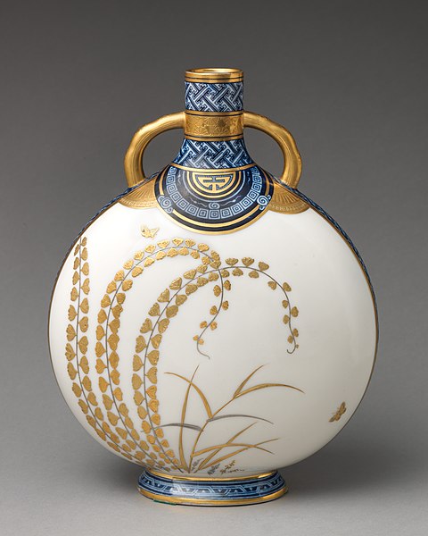 A disk-shaped pot with a pouring sprout on top.