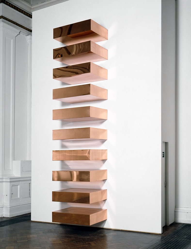 Installation of ten copper rectangular box units placed in a column (stacked) as if coming out of the wall.