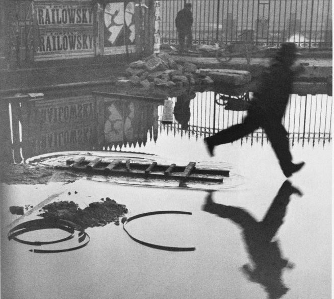 Photograph of a scene where a man appears to be leaping, capturing that exact instant.