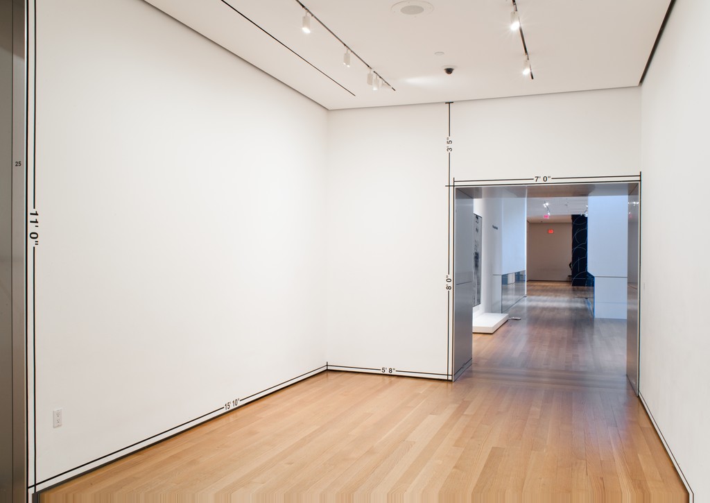 Image of Measurement Room by Mel Bochner. White walled room with measurements going all around.