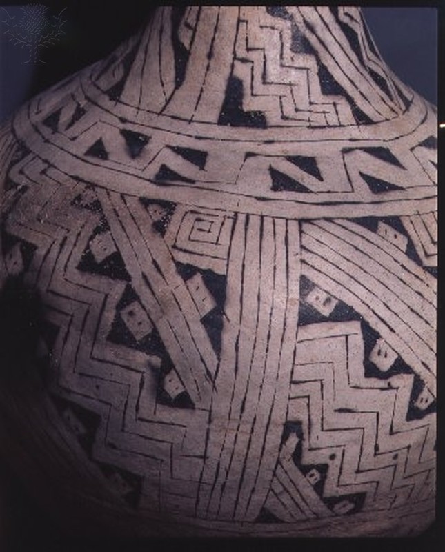 A water jug with elaborate black and white geometric patterns.