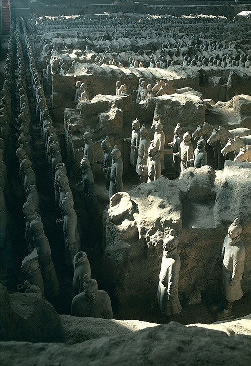 Hundreds of terracotta warriors lined up within a mausoleum.