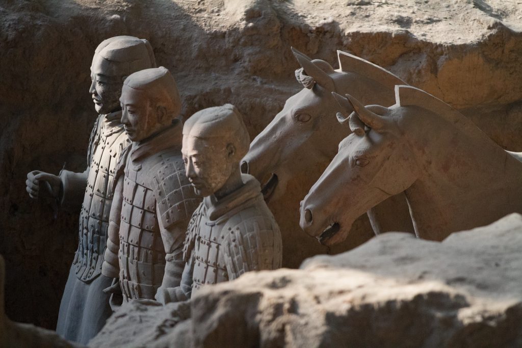 Closer view of three Terracotta Warriors with two horses behind them.