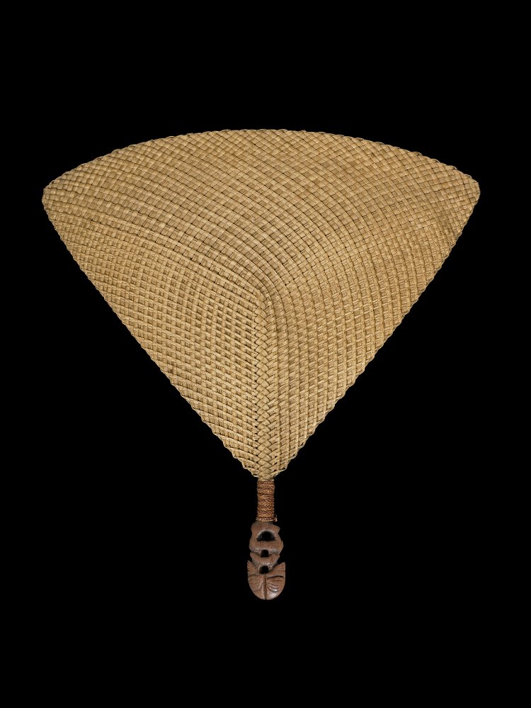 Image of a weaved hand fan with a carved figure handle.