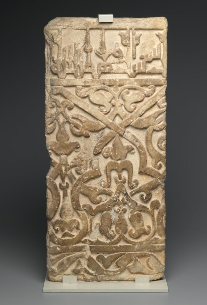 A stone panel with elaborate carvings.