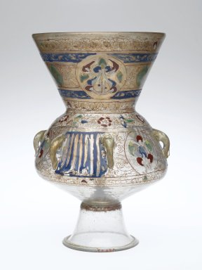 A lamp shaped somewhat like a vase on a glass base painted with fine details.