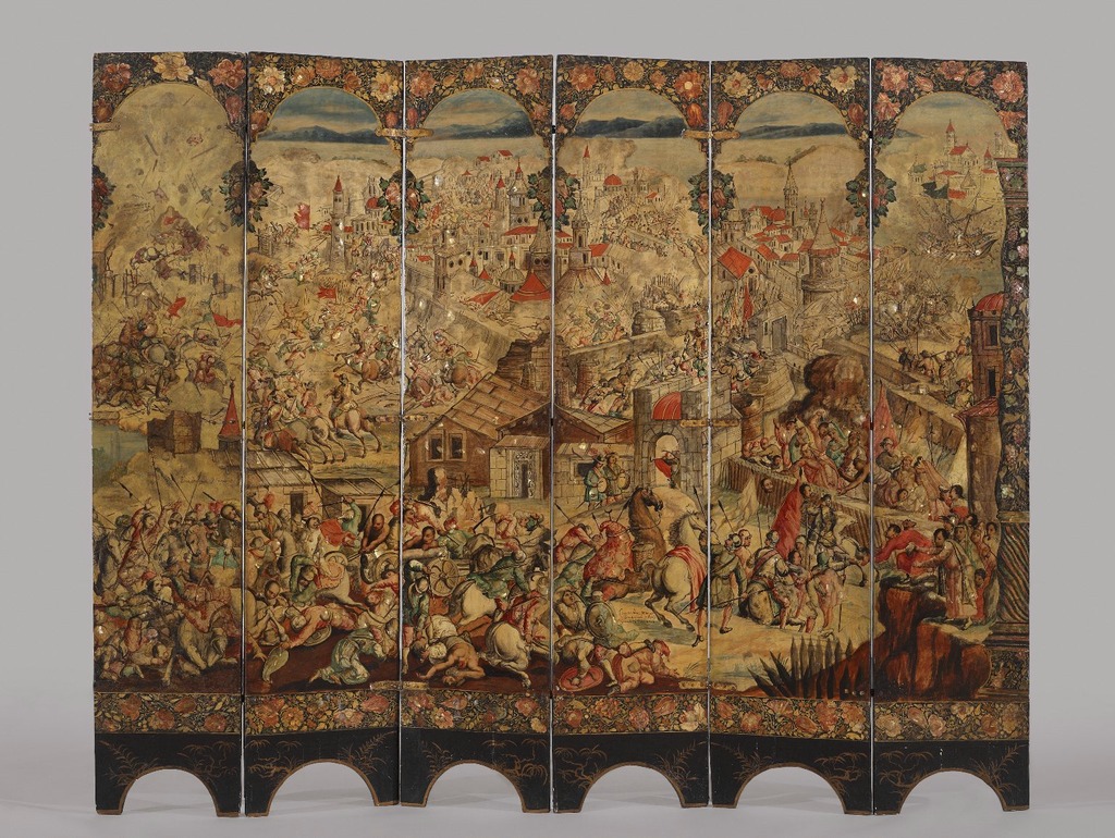 A large six-panel dressing screen open to show elaborately painted battle scenes outside of a walled city, as well as hunting.