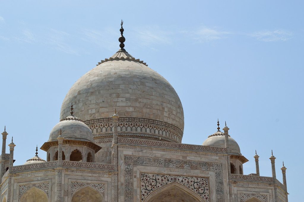 Close updetail of the dome of the TajMajhal showing mosaics and brickwork in the walls.