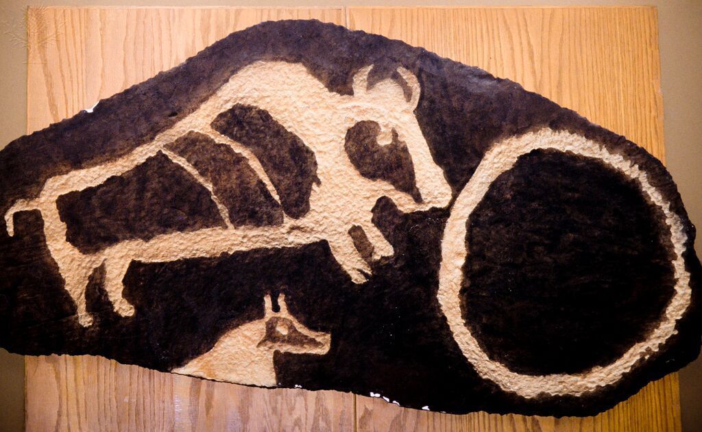 A drawing of a buffalo etched into a rock.