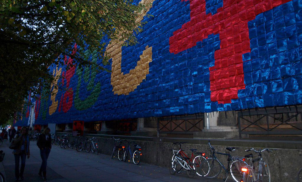 A portion of the So Sorry installation showing the red, yellow, gren, and blue backpacks arranged in Chinese letters.