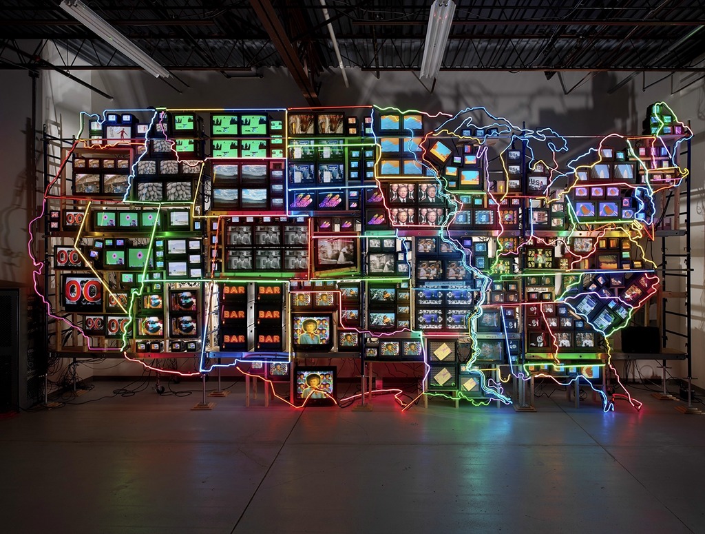 Image of Electronic Superhighway: Continental U.S., fifty-one channel television installation (including one closed-circuit television feed) arranged in the shape of the United States, made of custom electronics, muti-colored neon lighting, steel and wood; color, sound.