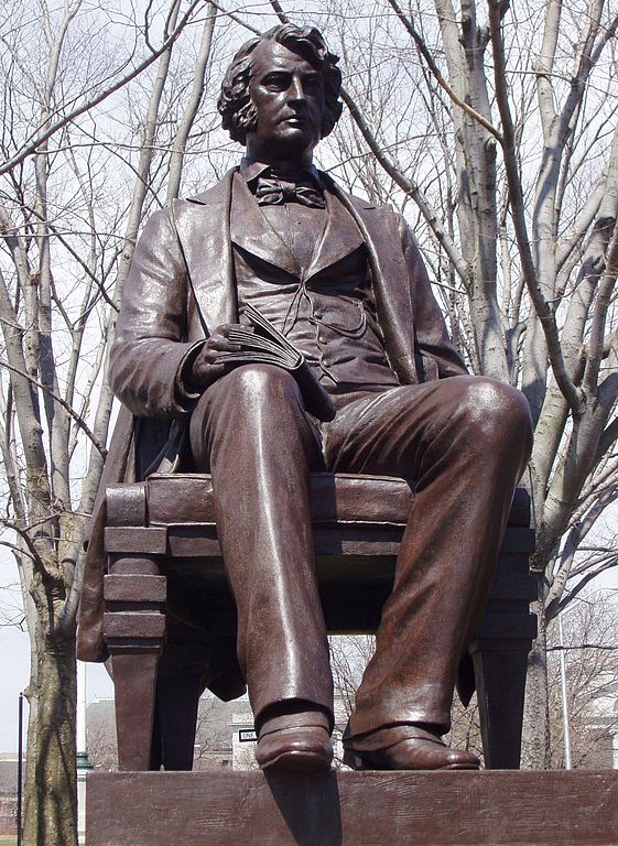 Sculpture of Charles Sumner seated with a book in his lap.