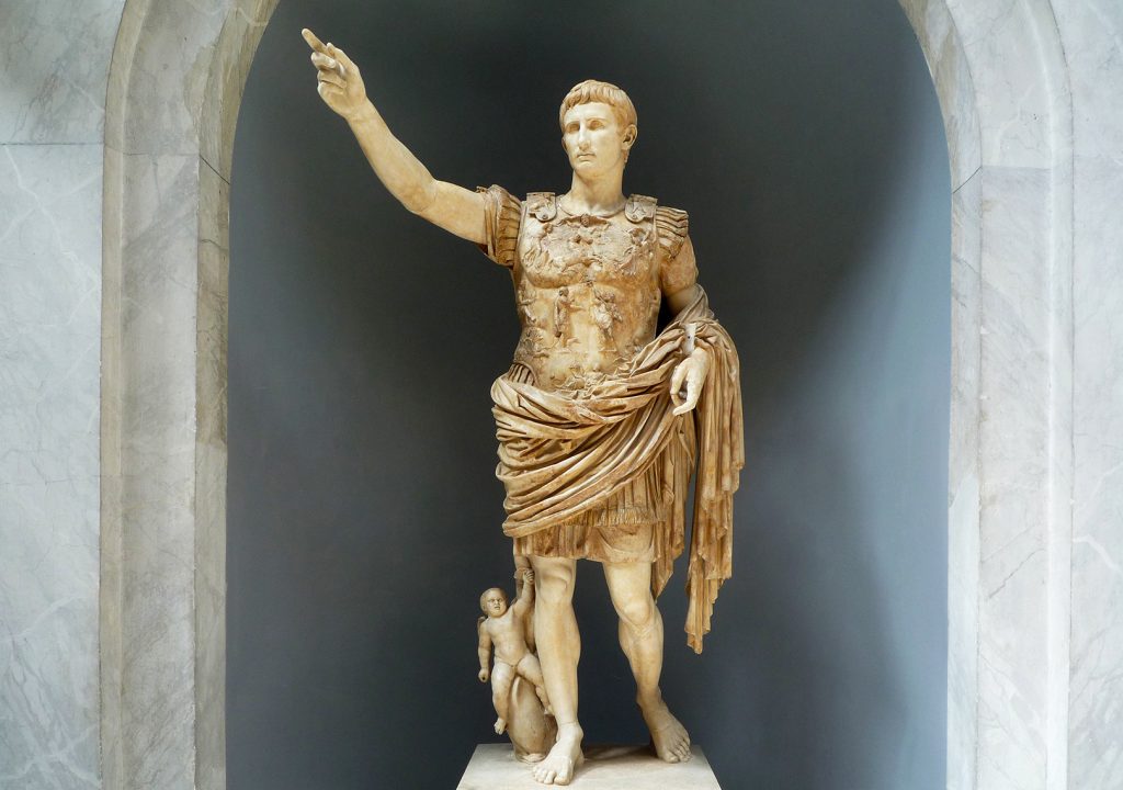 Image of statue of Augustus of Primaporta. Shown in armour with draping and showing Cupid riding a dolphin towards the bottom of his legs.
